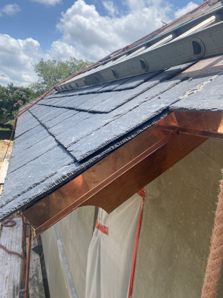 Slate roof with copper detailing