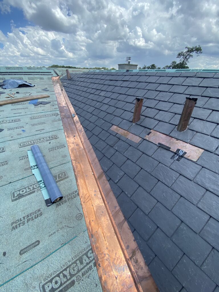 Slate roof installation with copper flashing