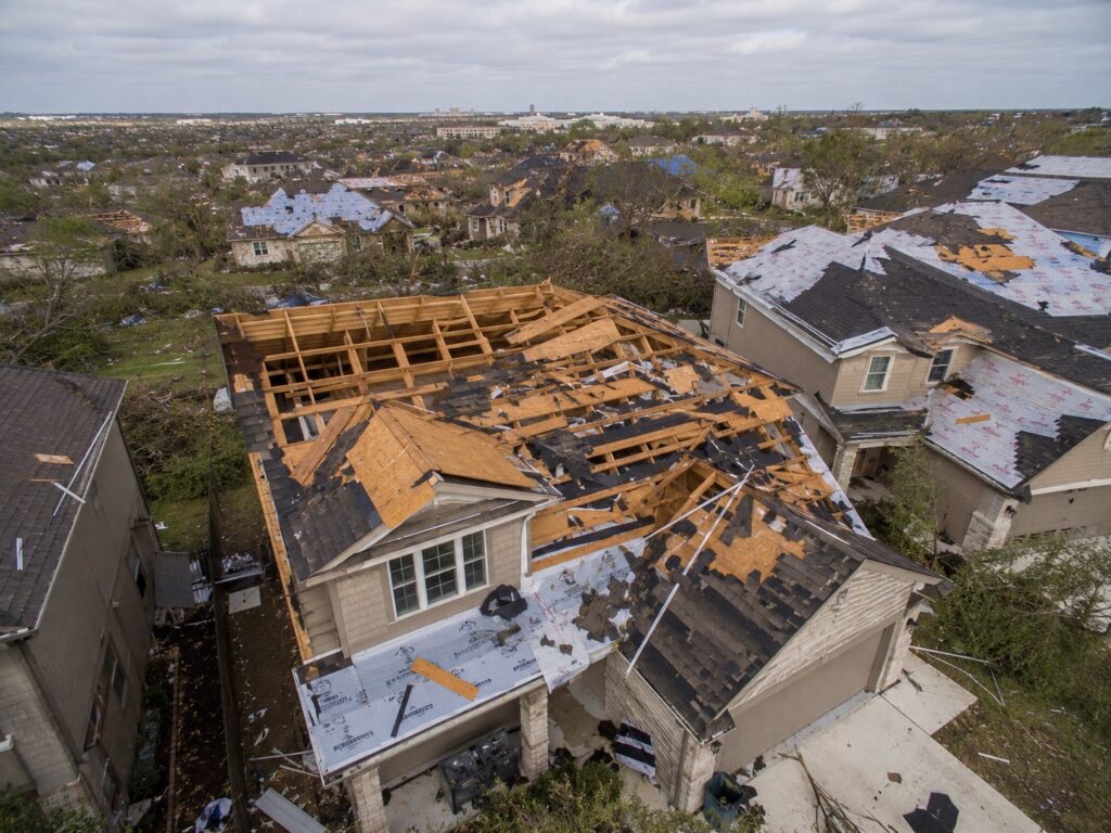 Severe roof damage from tornado aftermath.
